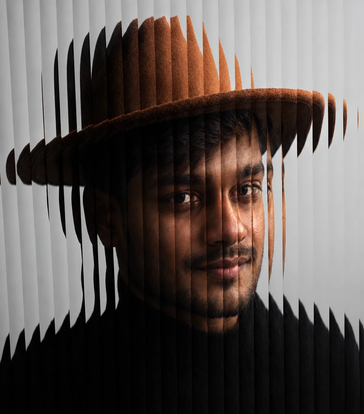 Creative portrait in a wide-brim hat with refracted light