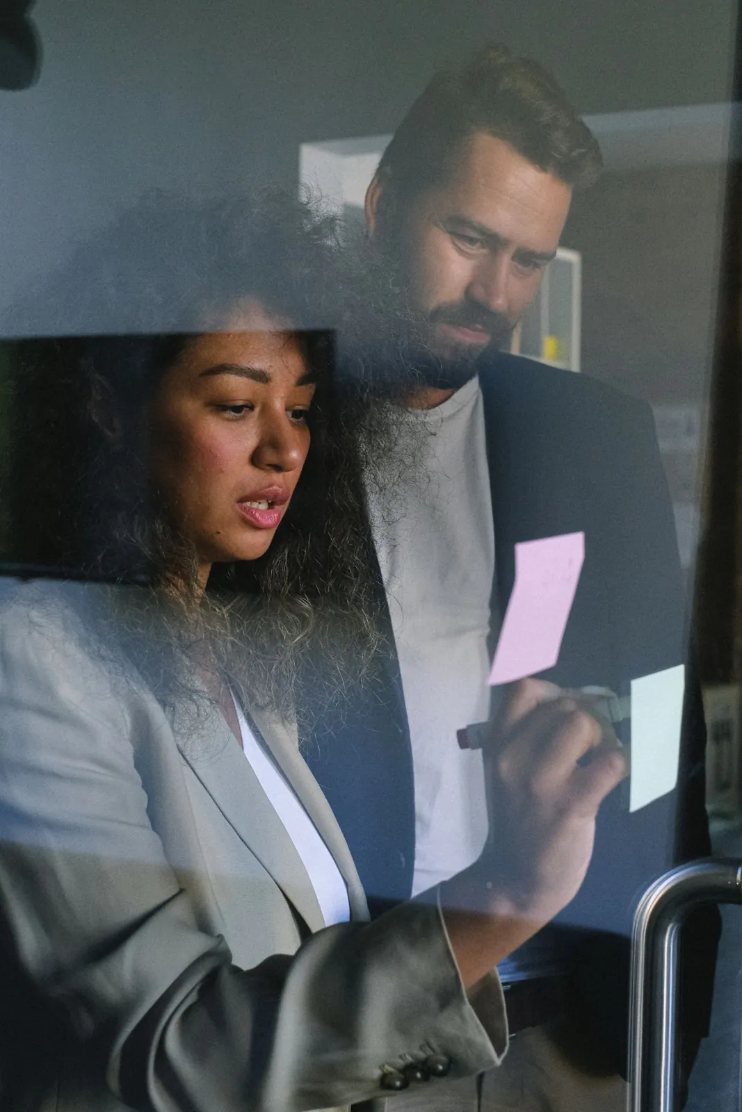 Professionals discussing ideas with sticky notes