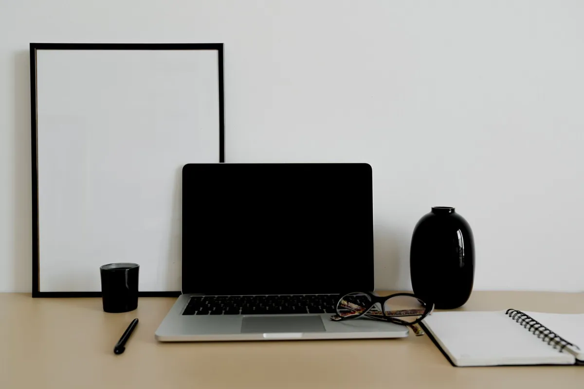 Laptop and notebook on an organized desk