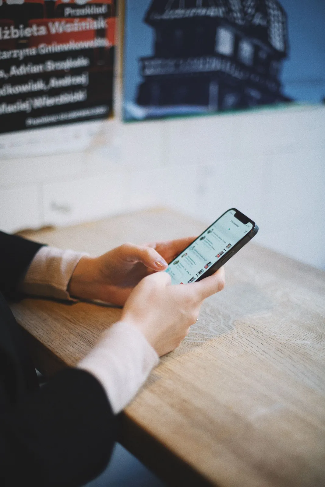 Hands using a social media app on a smartphone